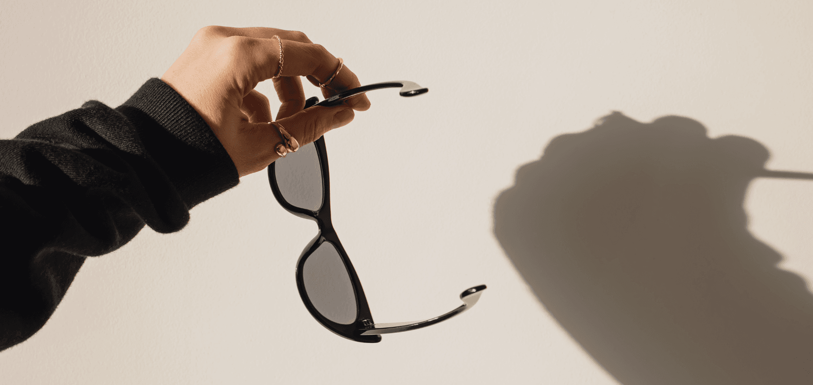 Picture of a hand holding sunglasses